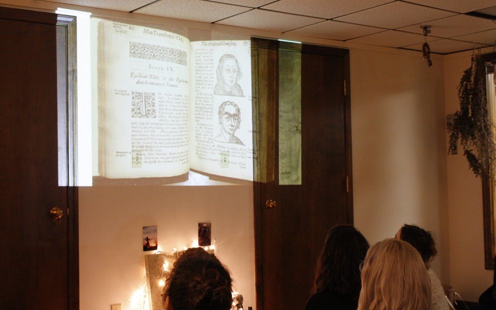 The audience of the lecture History of Witchcraft: Nasty Women look at a page of the Malleus Maleficarum, or Hammer of the Witches. The book, written in the 15th century, illustrated the defining facets of a witch, such as their eyebrow shape. 