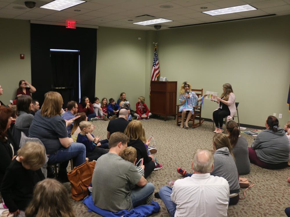 Evansville families in the North Park library listen to Florintine Dawn read &quot;The Very Hungry Caterpillar&quot; on Feb. 23. The reading was part of the city’s first Drag Queen Story Hour.
