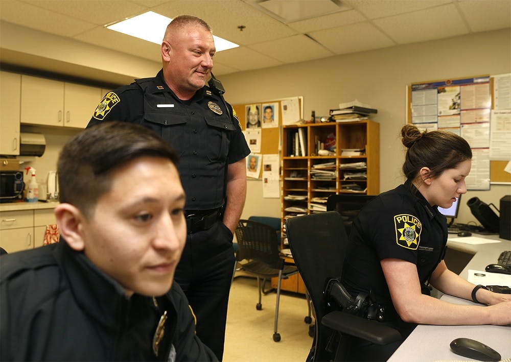 Andy Stephenson, IUPD captain, checks in with officers Joshua Sung, left, and Briana Guy Friday at IUPD station. After almost 20 years on the force, Stephenson said blue lights have only been used four times for legitimate emergencies. 