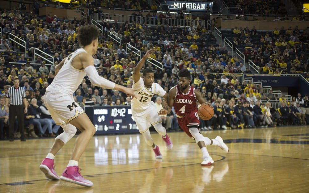 Junior guard Robert Johnson drives to the basket against Michigan in a loss Thursday.&nbsp;Johnson led IU in scoring with 14 points.