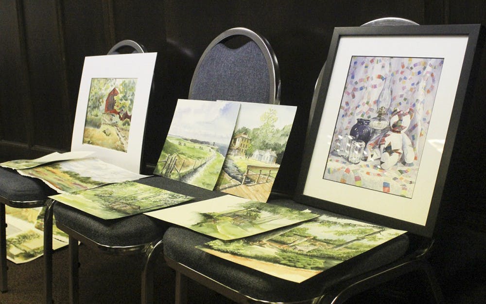 Pieces made by members of the Bloomington Watercolor Society sit on display during their “Show and Share” meeting on Monday night in First Christian Church. The group has formal meetings about once  a month, but also meets several times a month for workshops and to paint together.