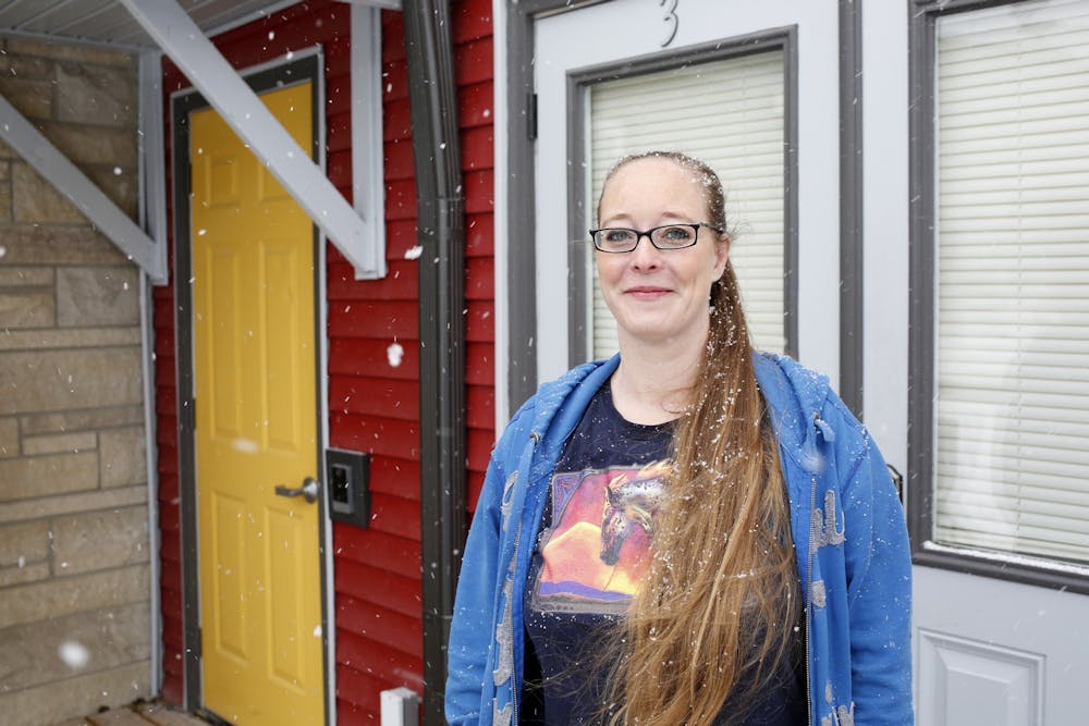 <p>Katie Norris poses Jan. 28, 2022, in front of Robin &amp; Trisha&#x27;s House, a transitional housing facility for men experiencing homelessness. Norris opened the facility last May.</p>