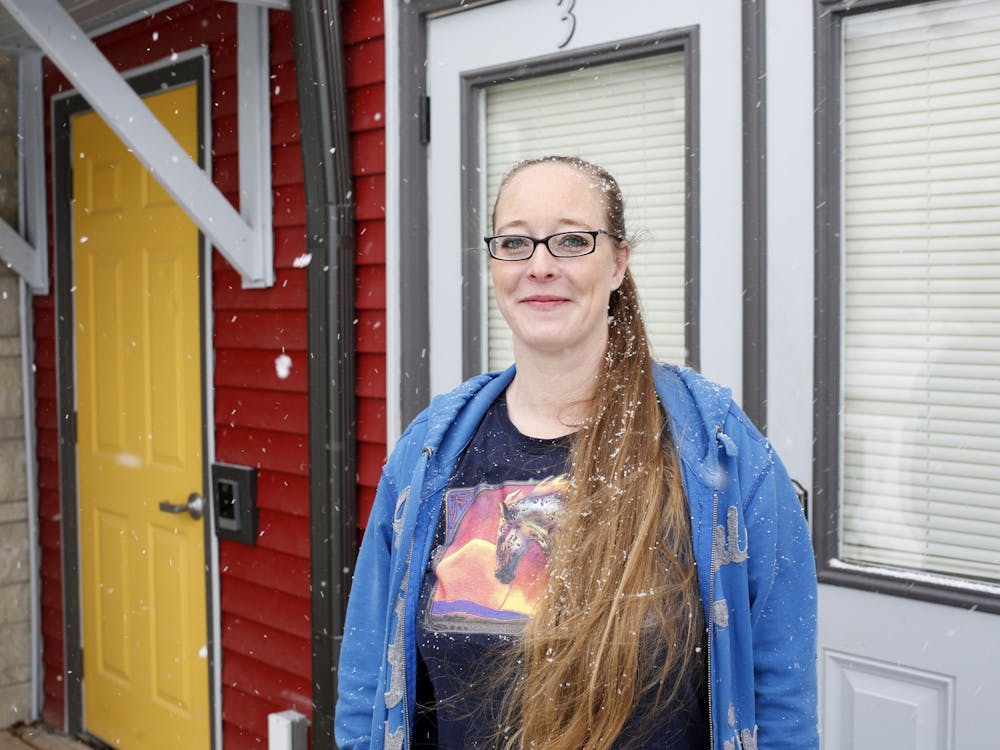 Katie Norris poses Jan. 28, 2022, in front of Robin &amp; Trisha&#x27;s House, a transitional housing facility for men experiencing homelessness. Norris opened the facility last May.