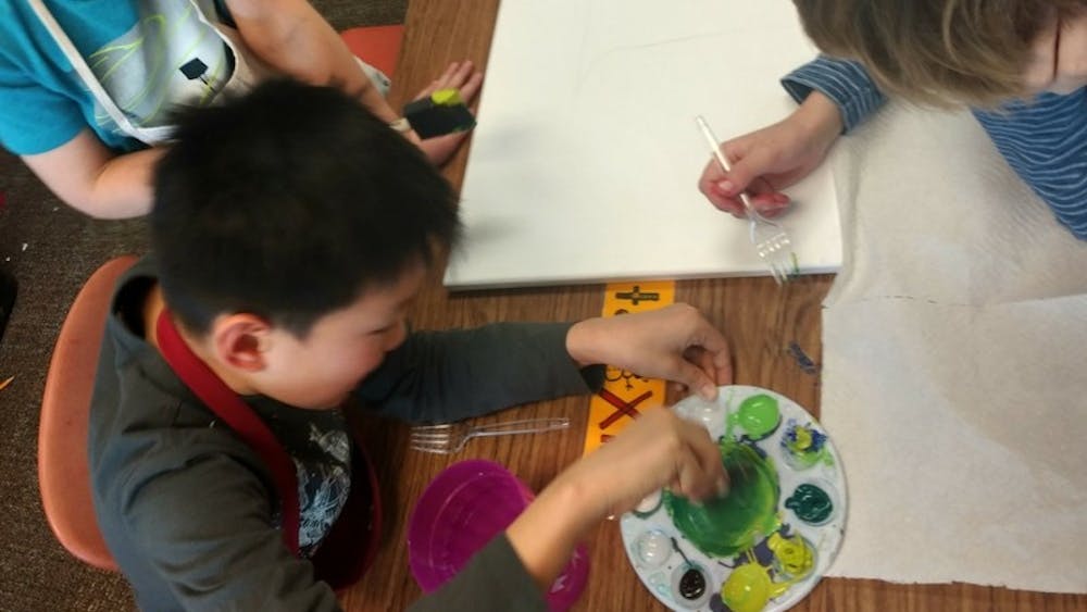 Second grade students at Rogers Elementary School draw trees for an exhibit at Gather, a Bloomington art gallery. The students learned about trees native to Southern Indiana forests in class.