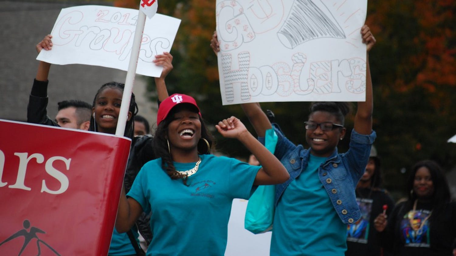 Members of the Groups Scholars Program cheer as they march along Kirkwood Avenue at the Homecoming Parade Friday.