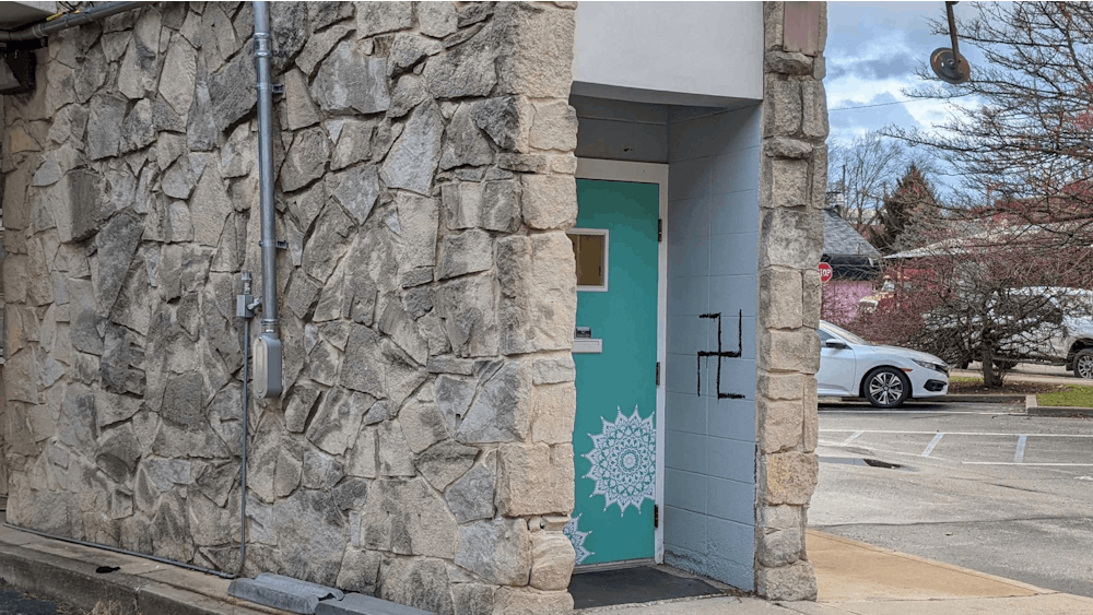 A swastika is seen Dec. 15, 2021, graffitied onto a wall of a building near the corner of Sixth and Madison streets. This was the sixth swastika discovered in Bloomington in the past three weeks.
