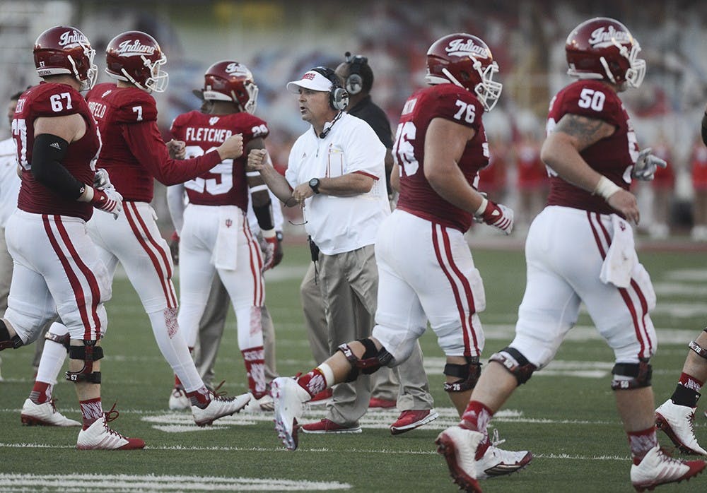 Head Coach Kevin Wilson fist bumps with quarterback Nate Sudfeld during the game against Western Kentucky on Saturday at Memorial Stadium. The Hoosiers won, 38-35.