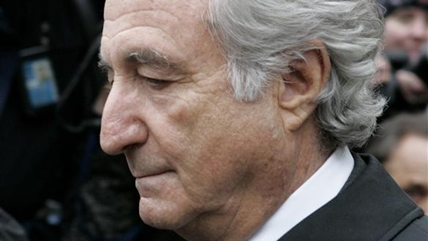 In this March 10, 2009, photo, Bernard Madoff exits Manhattan federal court in New York. U.S. District Judge Denny Chin said Monday that the federal probation department recommends that Madoff get 50 years in prison.