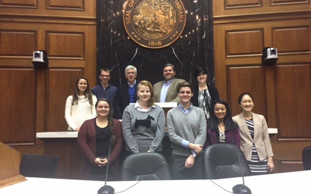 <p>Eight of the high school and college New Voices of Indiana team members meet at the Indiana Statehouse, Wednesday, Dec. 7 to draft legislation for a press freedoms bill. They met with stakeholders who would be interested in the legislation.</p>