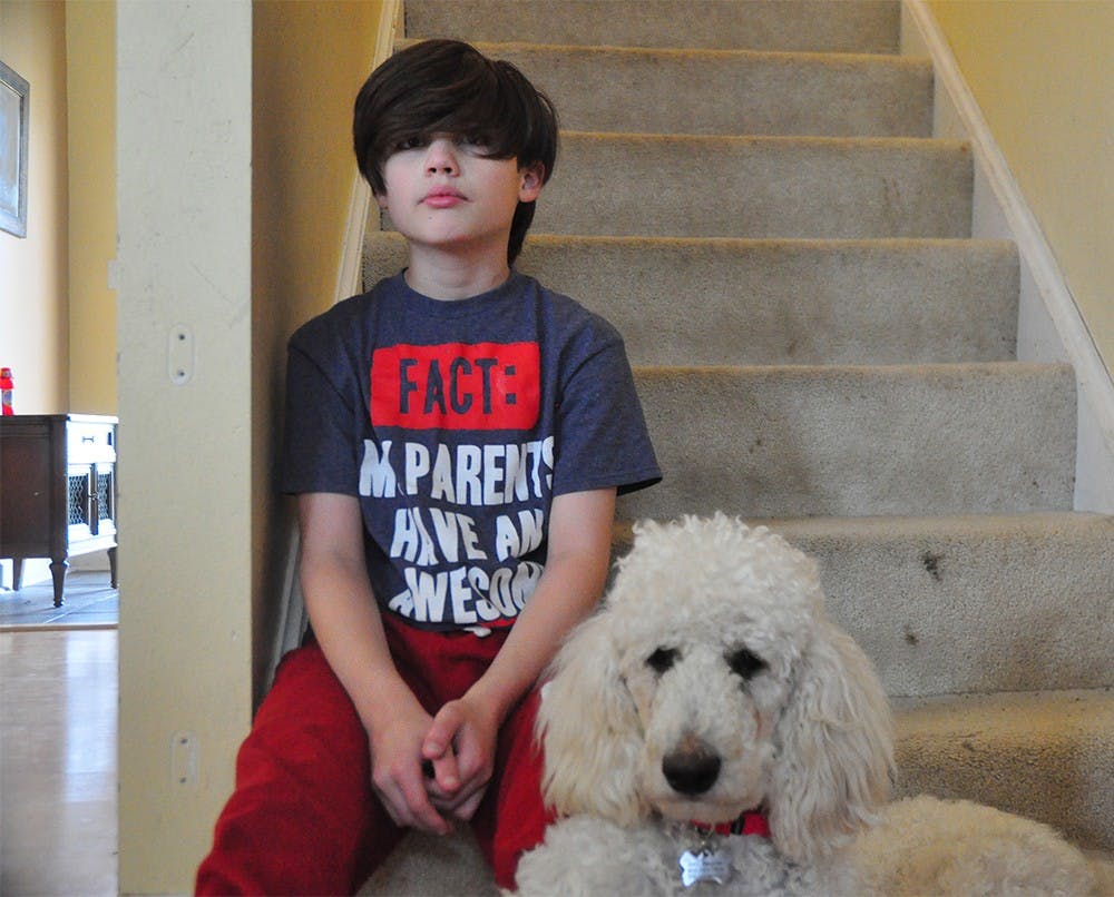 Noah poses with his service dog, Appa.