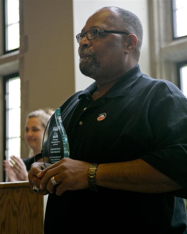 Chair for Food Campaign Hugh Barbry accepts an outstanding volunteer award Thursday evening in the Tudor Room. The award was presented by the Hoosier Hills Food Bank, who presented many volunteers and groups with awards, for their service to the community by helping with the food bank.