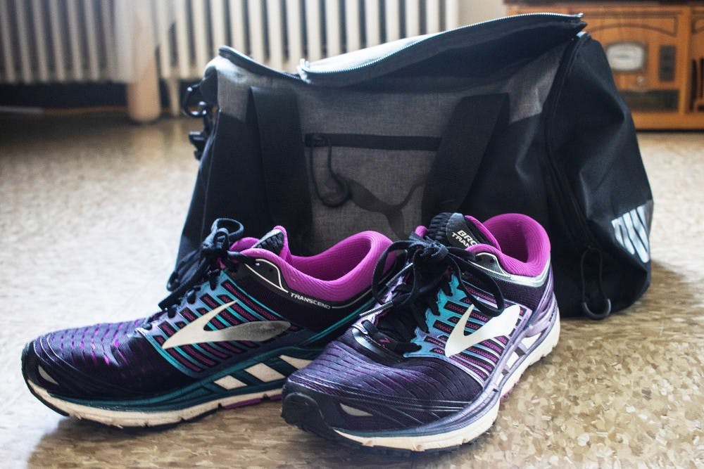 Running shoes and a gym bag sit on the floor May 17 in University East Apartments. Students can stay healthy on campus by going on runs and keeping their workout gear on hand in a gym bag.