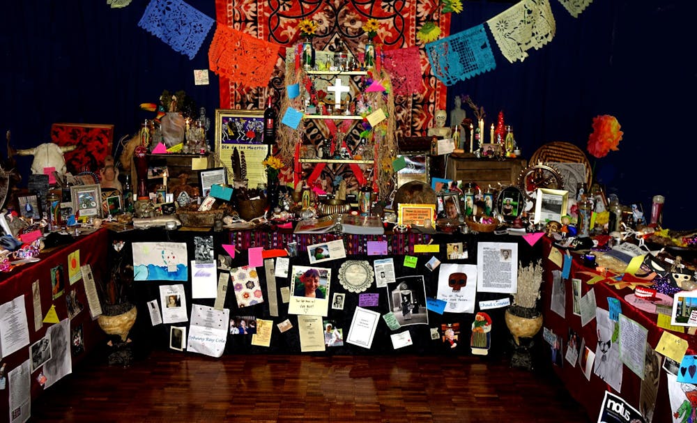 <p>The Bloomington Day of the Dead Community Altar is decorated with photos of people who have died, flowers, statues, string lights and other miscellaneous objects. The 2021 altar is located in the Monroe County History Center through Nov. 2.</p>