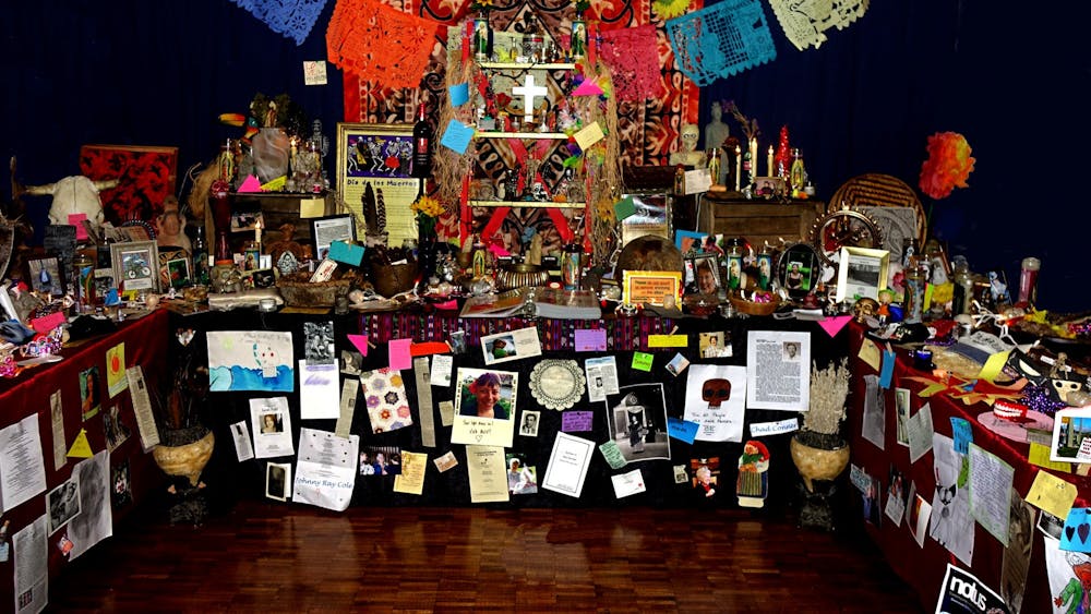 The Bloomington Day of the Dead Community Altar is decorated with photos of people who have died, flowers, statues, string lights and other miscellaneous objects. The 2021 altar is located in the Monroe County History Center through Nov. 2.