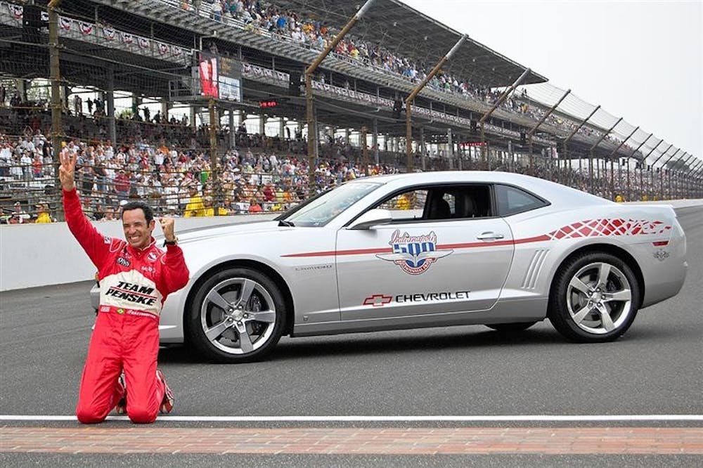 Helio Castroneves holds three fingers in the air following his third Indianapolis 500 win Sunday afternoon at Indianapolis Motor Speedway.

