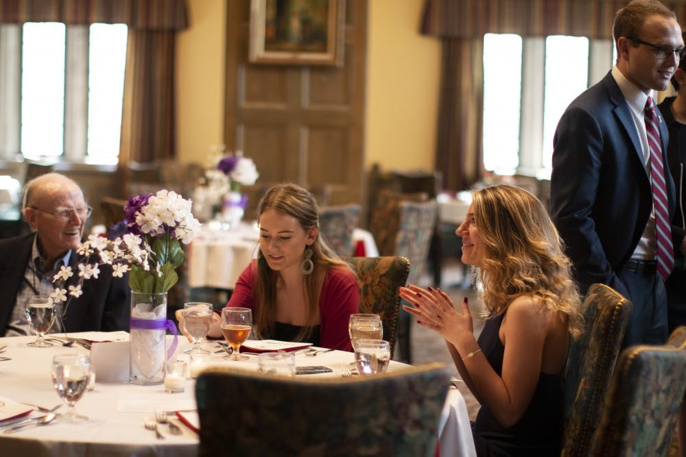<p>Members of the IU law fraternity Phi Alpha Delta talk and eat April 10 in the Tudor Room of the Indiana Memorial Union. The fraternity celebrated its fourth annual fundraiser for Indiana Legal Services.</p>