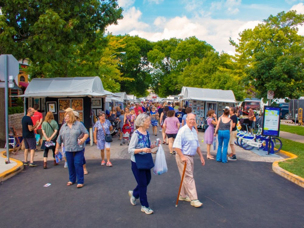 Attendees line the street Saturday for the Fourth Street Festival of the Arts and Crafts. The festival, which started in 1976, is an annual, two-day event organized by local artists who invite 120 artisans from around the country.&nbsp;