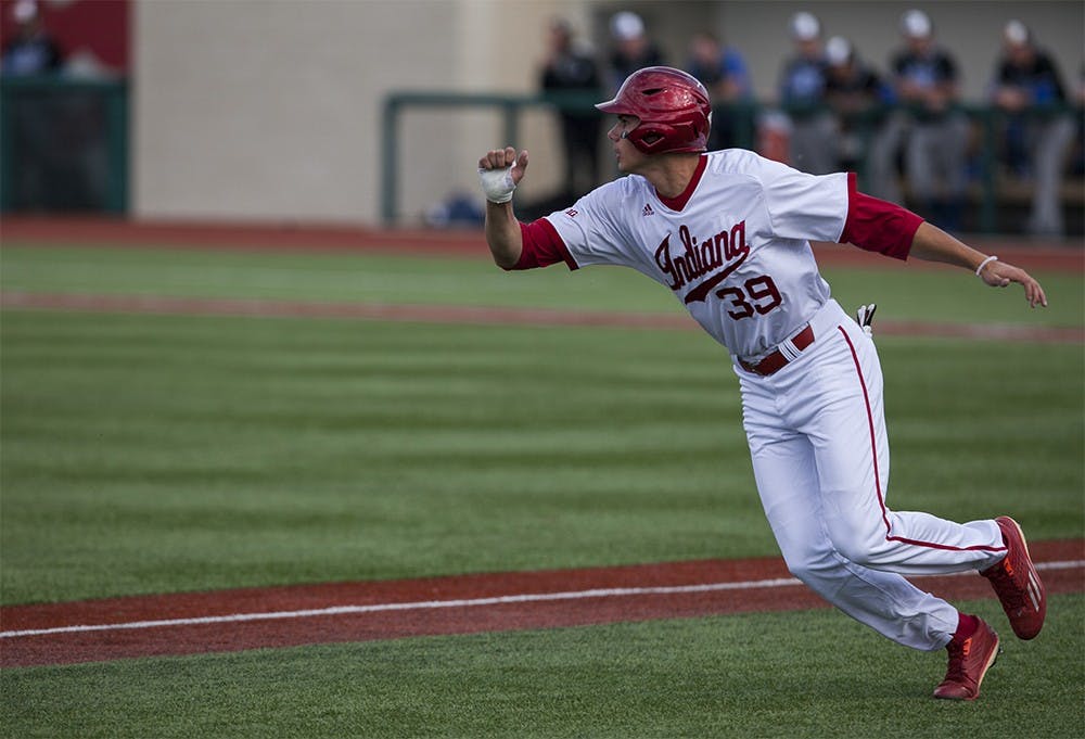 Sophomore center fielder Craig Dedelow runs back to third base on Wednesday at Bart Kaufman Field.