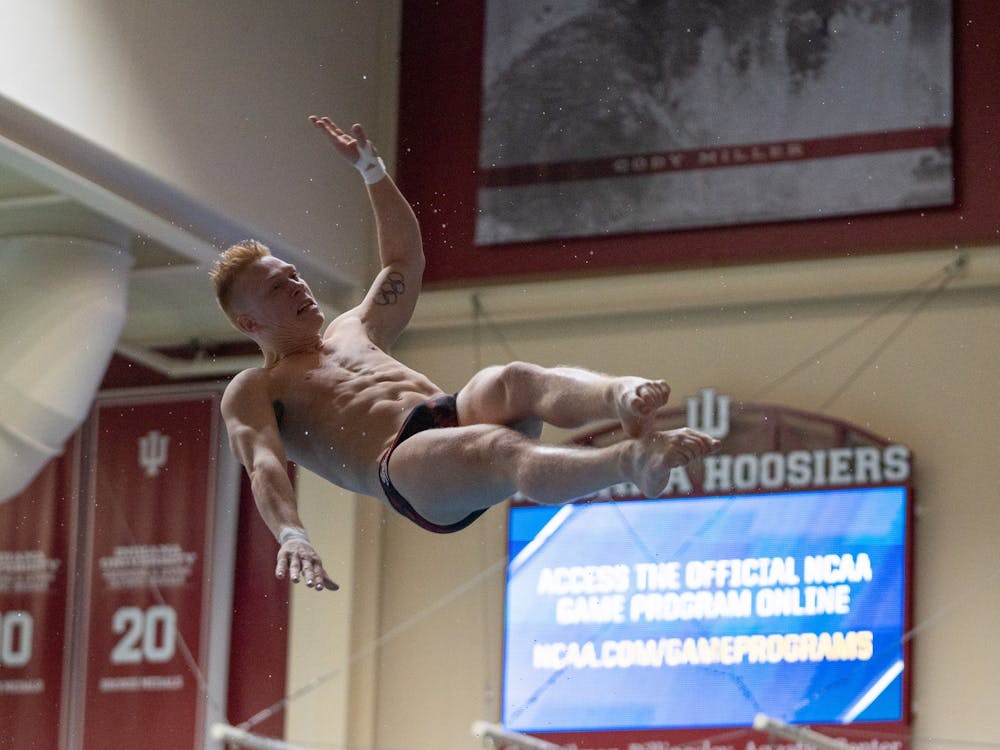 Graduate diver Andrew Capobianco twists in the air during a dive on March 9, 2023, during the NCAA Zone C men&#x27;s diving championship at the Councilman-Billingsley Aquatics Center. IU dominated the podium with Capobianco, Quentin Henninger and Carson Tyler taking first, second and third places respectively.