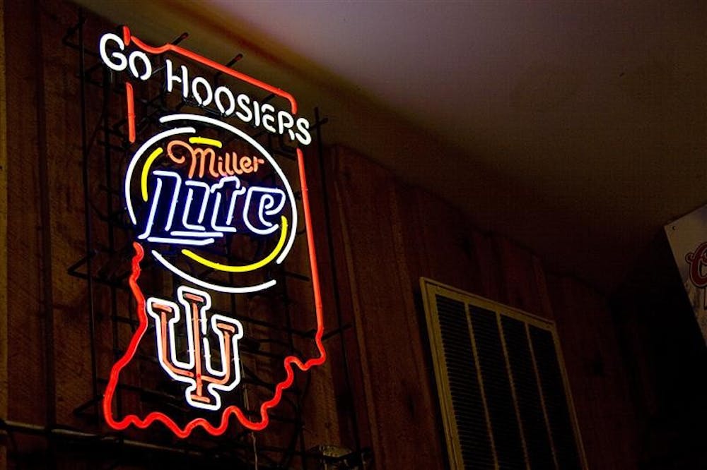 This sign displayed outside of Nick's English Hut, has caused controversy because IU's logo is represented next to an alcoholic company 