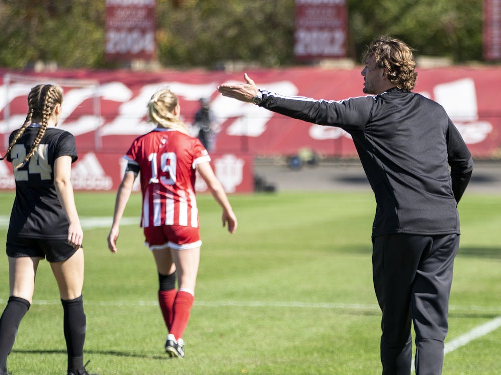 Indiana women&#x27;s soccer head ﻿coach Erwin van Bennekom gives advice to a player Oct. 27, 2019, at Bill Armstrong Stadium. Indiana will face the University of Louisville Thursday night.