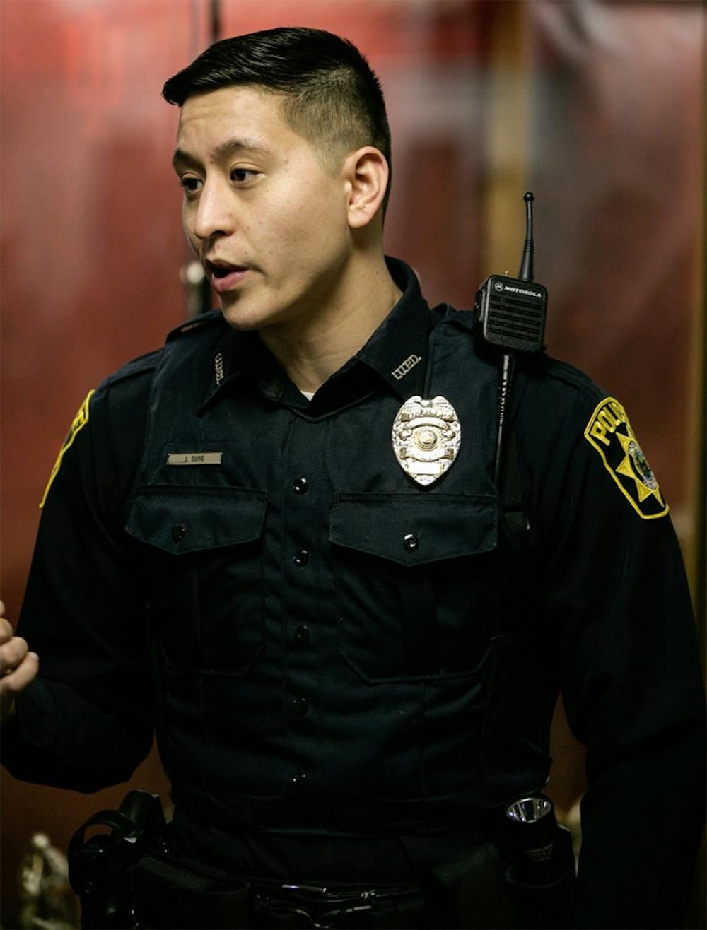 IUPD officer Joshua Sung talks to patrons entering Assembly Hall last Wednesday for a basketball game against Nebraska. Sung is one of many officers who provides security throughout Assembly Hall for the basketball games.