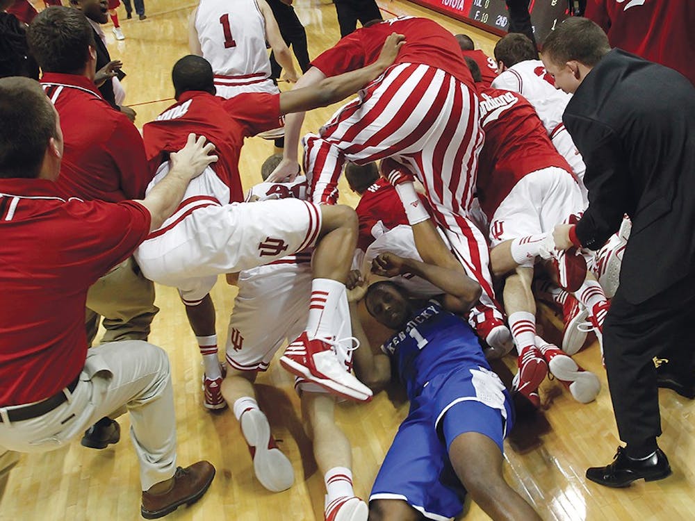 IU players storm the court and jump over Kentucky's Darius Miller (#1) and onto then-junior Christian Watford after he made the game winning basket against Kentucky on Dec. 10 at Assembly Hall. Kentucky was ranked #1 in the country. 