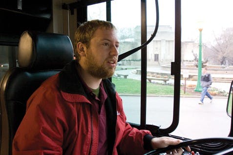 IU senior Dan Goldblatt drives the Auditorium Shuttle route Thursday evening outside the IU Auditorium. Goldblatt stated, "I saw an ad at the Career center that said $12 an hour and I said 'Alright'."
