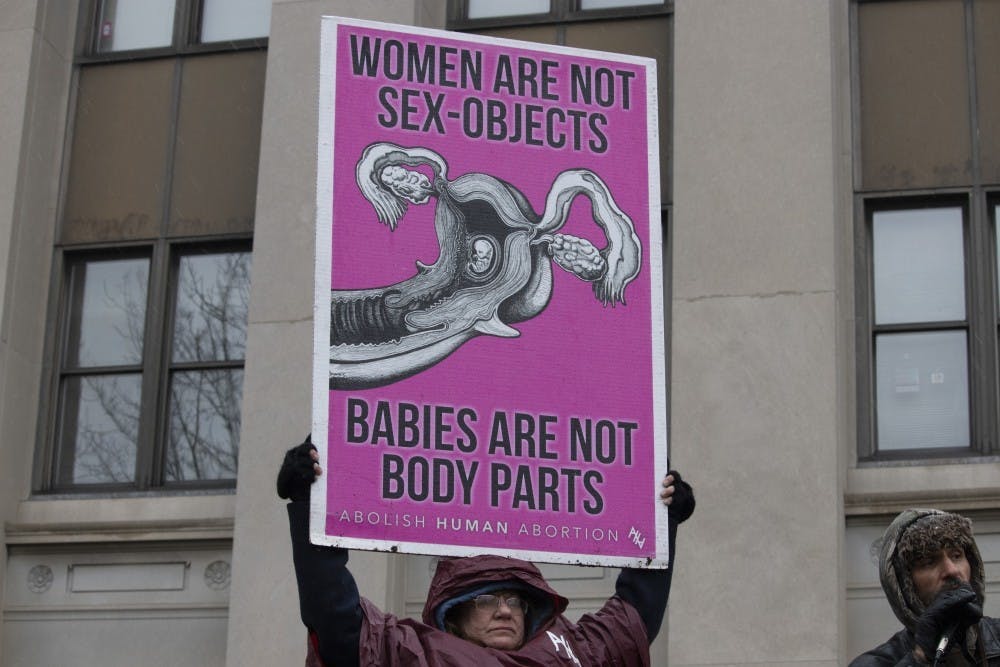 <p>An anti-abortion protestor stands at the Women’s March on Jan. 19, 2019, in Indianapolis. Texas’s new abortion law prohibits abortions after six weeks of pregnancy.</p>
