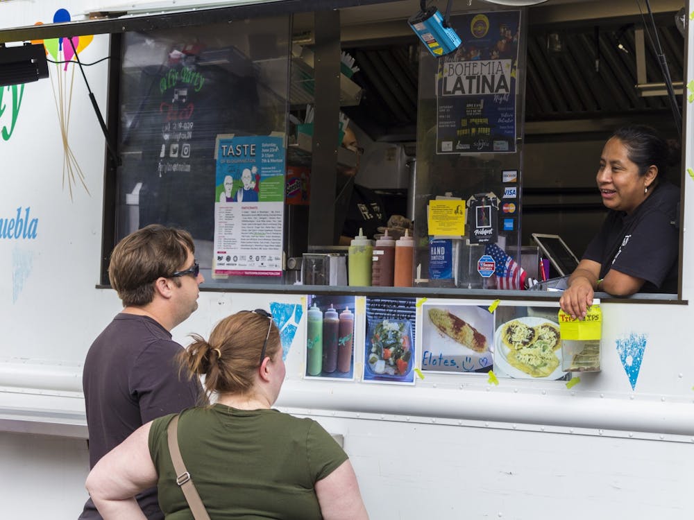 Attendees order food from an employee of Pili’s Party Taco truck June 23, 2018, as part of the 36th annual Taste of Bloomington. This year&#x27;s Taste of Bloomington will be replaced with a week-long “Taste To-Go” event from June 20 to June 26.