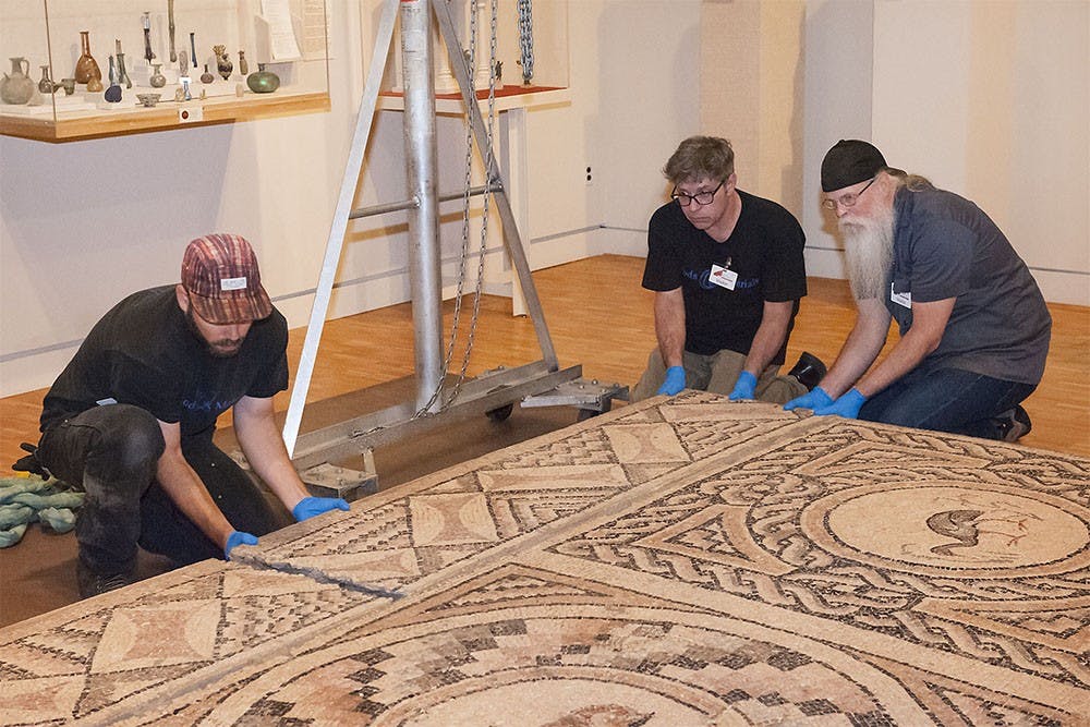 Workers remove a Roman mosaic from the IU Art Museum.  The piece will be shipped to the J. Paul Getty Museum in Los Angeles where it will later be displayed.