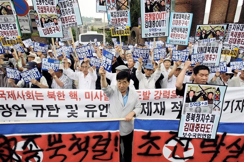 South Korean protesters shout slogans during a rally against North Korea's nuclear program while denouncing the ninth anniversary of the June 2000 summit between the South Korean President Kim Dae-jung and North Korean leader Kim Jong Il, in front of the former South President Kim's house in Seoul, South Korea, Sunday, June 14, 2009. North Korea's communist regime has warned of a nuclear war on the Korean peninsula while vowing to step up its atomic bomb-making program in defiance of new U.N. sanctions. The Korean read "'Annihilate North Korea at the start of war and Support U.N. sanctions." 