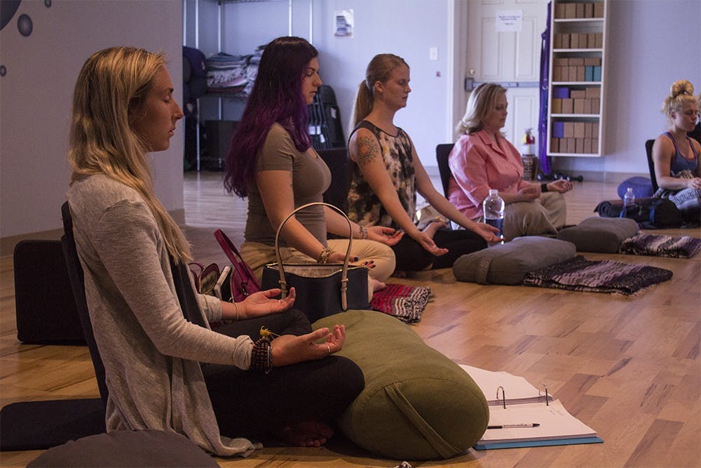 Participants chant and meditate as part of the Ayurveda in relation to yoga class taught at Vibe Yoga and Pilates studio. The class is a four day training with Dr. Indu Arora.