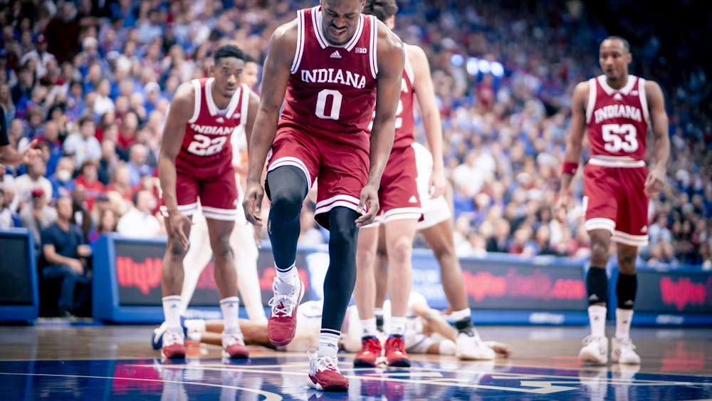 Graduate guard Xavier Johnson grabs his foot in the first half Dec. 10, 2022, at the Allen Fieldhouse in Lawrence, Kansas. On Saturday, it was announced that Johnson would not return for the remainder of the season. 