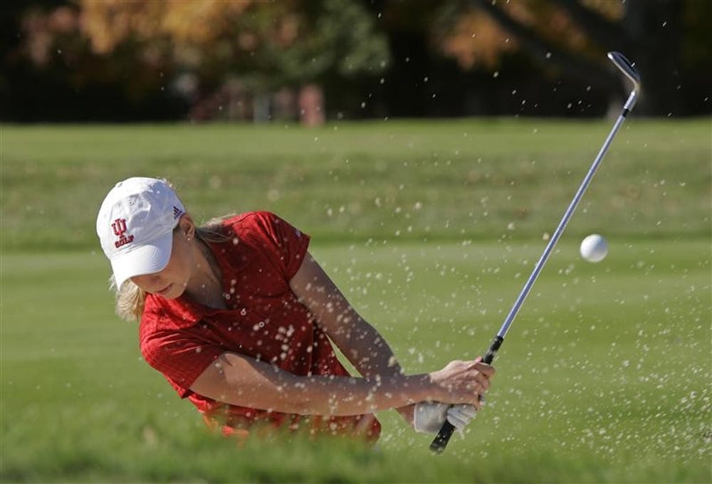 IU senior women's golfer Amber Lindgren practices hitting out a sandtrap on Oct. 31 at the IU golf practice facilities.