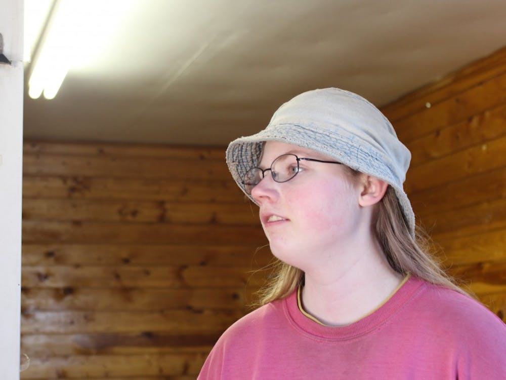Larry Howard's 15-year-old daughter, Elena, stands near the refrigerator where Maple Valley Farm keeps eggs. Elena is responsible for taking care of the laying hens.&nbsp;