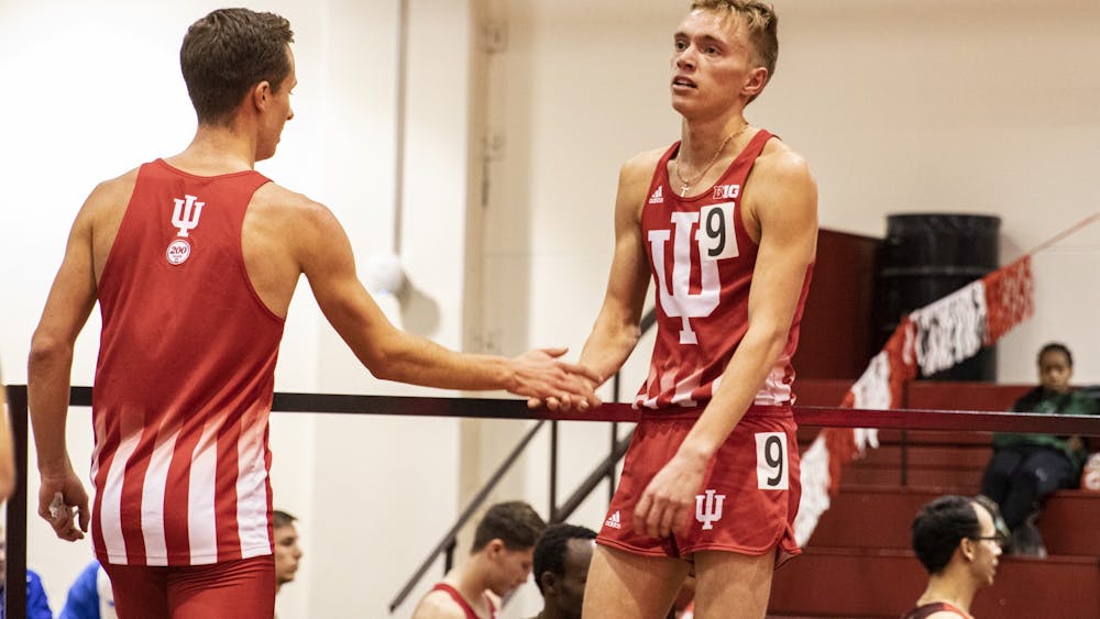 Junior distance runner Ben Veatch looks at the race results after running the 3,000 meter run Feb. 14 in Gladstein Fieldhouse. Members of IU Track and Field have kept in touch with one another by participating in challenges, group texts and Zoom meetings.