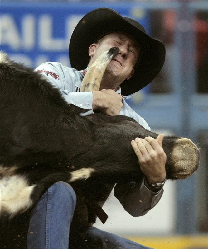 Les Shepperson, of Midwest, Wyo., competes during the first go-round of steer wrestling at the National Finals Rodeo at the Thomas & Mack Center Thursday in Las Vegas.