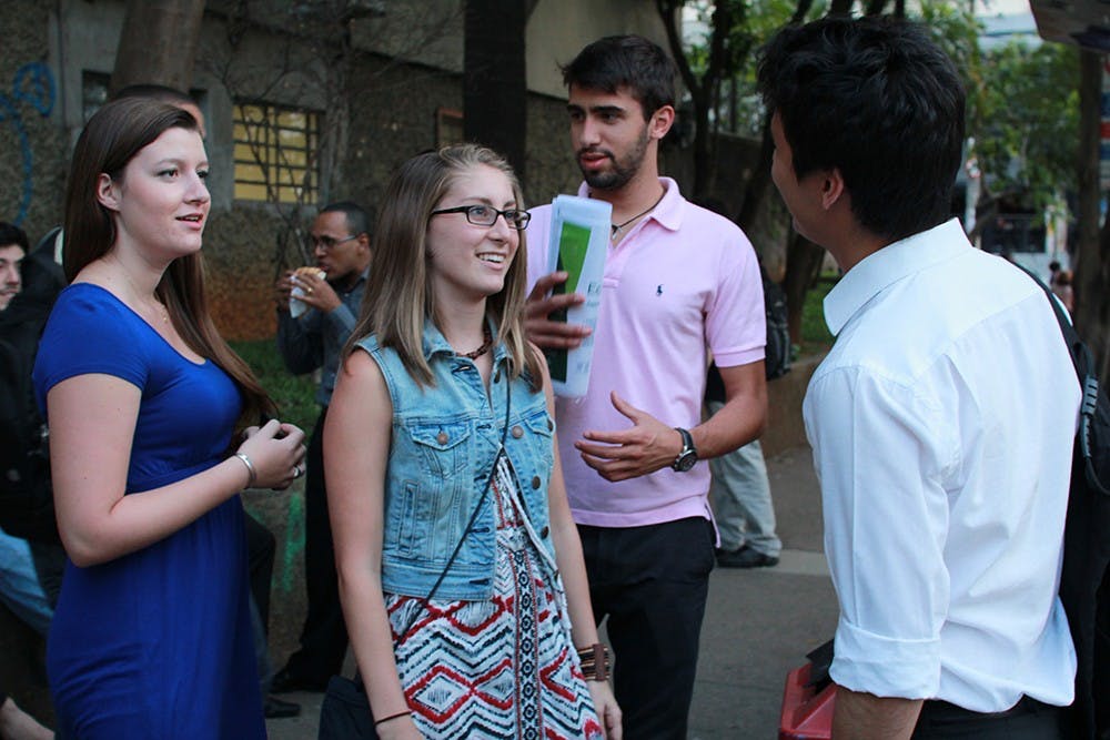 Jules Daugherty, an IU student studying abroad in Brazil, talks with Lucas Saito Valeriano on Wednesday night at their university in São Paulo. Daugherty says she has struggled with handling the degree of sexism even within platonic friendships here in Brazil.