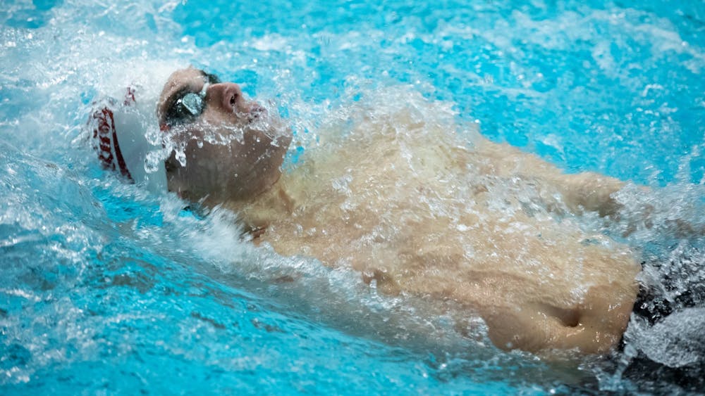 Sophomore Logan Graham swims in the men&#x27;s 100-yard backstroke race on Jan. 28, 2022, at the Counsilman Billingsley Aquatic Center. Indiana took first place at the 2022 Big Ten Swimming and Diving Championships over the weekend.