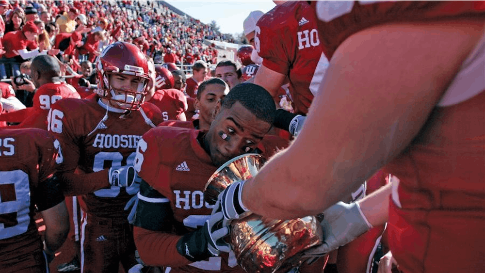Then-sophomore safety Brandon Mosley prepares to spit into the Old Brass Spittoon after the Hoosiers' 46-21 victory against Michigan State in 2006 at Memorial Stadium. IU's win marked its first against the Spartans since 2001.&nbsp;