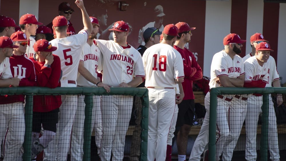 The IU baseball team cheers and watches the game March 27 at Bart Kaufman Field. IU lost to Kent State University, 9-8.