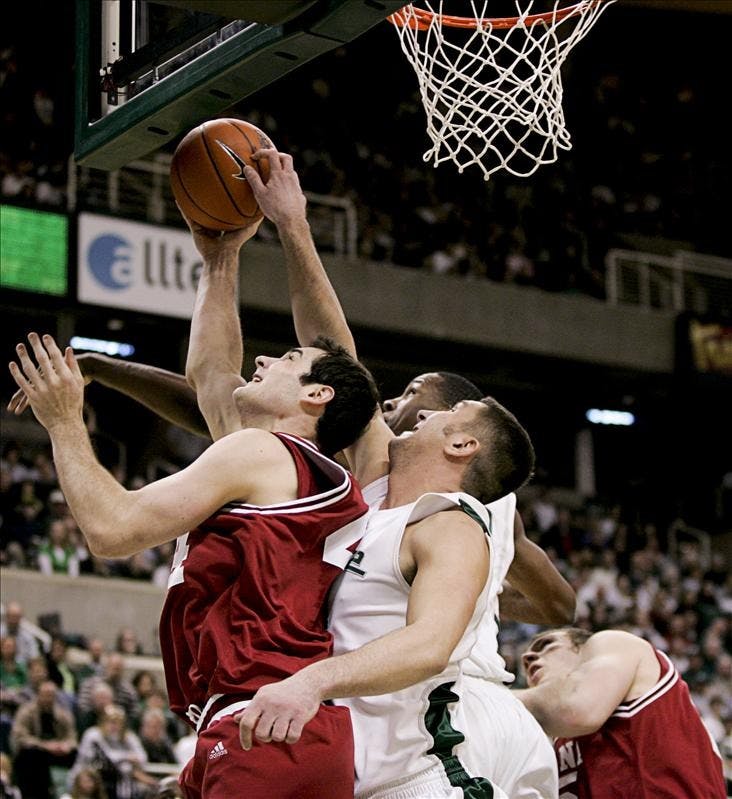 Senior forward Kyle Taber goes for a lay-up against Michigan State senior center Goran Suton during the first half of IU's 75-47 loss to Michigan State Saturday in East Lansing, Mich.