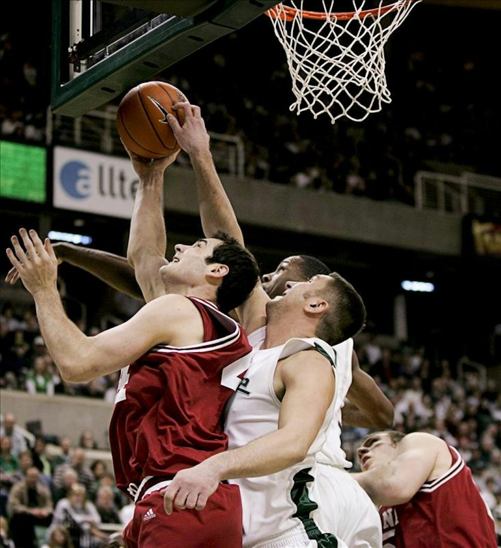 Senior forward Kyle Taber goes for a lay-up against Michigan State senior center Goran Suton during the first half of IU's 75-47 loss to Michigan State Saturday in East Lansing, Mich.