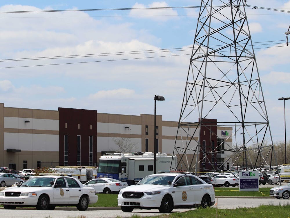 Police cars block the entrance to the FedEx Ground Plainfield Operations Center on Friday in Plainfield, Indiana. The FedEx center was the site of a mass shooting Thursday, where a gunman killed eight people and then himself. 