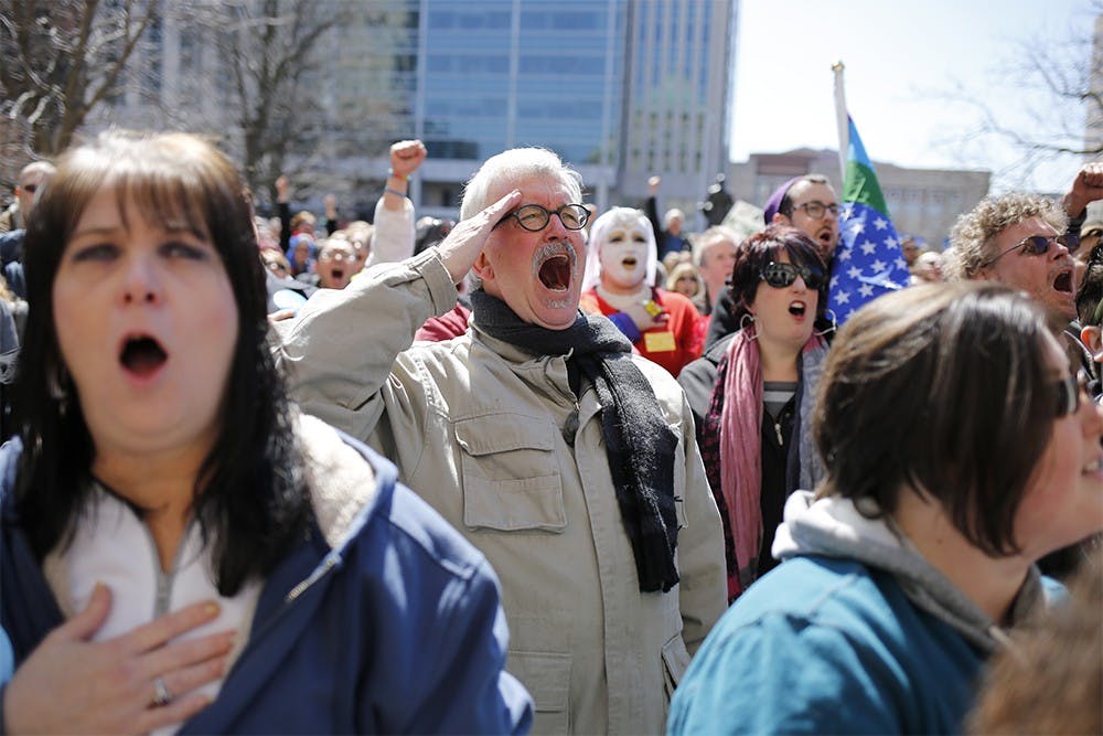 Vietnam War Veteran, Bob Motz, screams, "for all!" at the end of the Pledge of Allegiance, which marked the start of the rally outside the Indiana Capital Building. "I was sickened by what Pence said," said Motz. "This does not represent what most of Indiana feels. I think everyone should be free and feel comfortable here."

