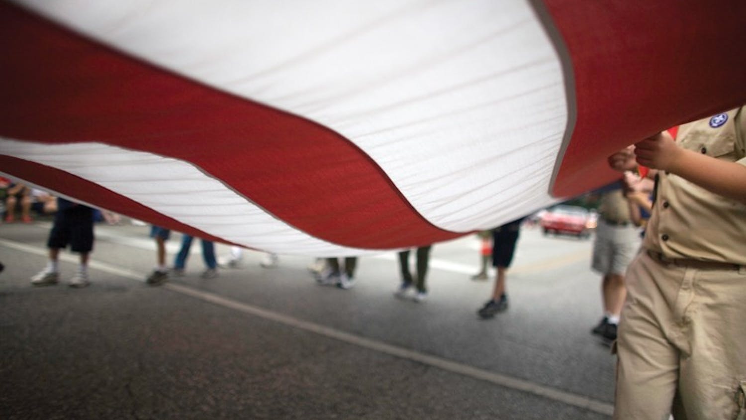 IDS FILE PHOTO
Participants in the Independence Day parade carry the American flag July 4, 2007.