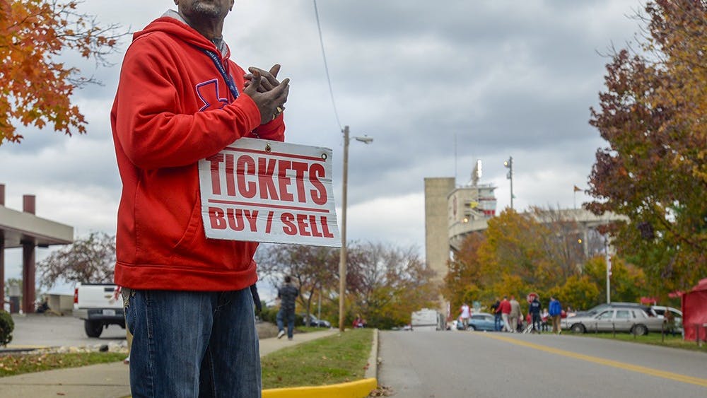Indianapolis native Brian Stapleton, 50, awaits ticket buyers on Indiana Ave. before IU's homecoming football game against Michigan State. Stapleton, known more by his alias, Jeffery, has been scalping tickets for 18 years, and often ventures to Bloomington in hopes of making a profit, even though ticket sales for IU football are worst in the Big Ten. The ticket scalper on the street corner is a dying breed, as online sites like Stubhub and Ticketmaster are making scalping obsolete.