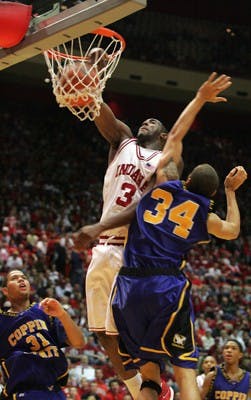 IU senior forward D.J. White dunks the ball during the second half of IU's 73-46 victory against Coppin State Saturday afternoon at Assembly Hall. White led the team with 21 points and 8 rebounds.
