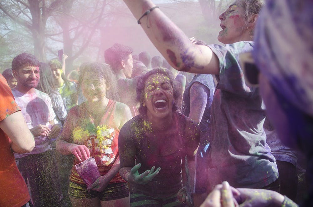 Meelia Palakal laughs as colored powder is thrown at the Indian Student Association's Holi Festival outside of Collins Living Learning Center on April 17. 
